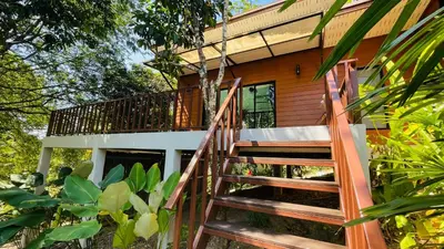 a staircase leading up to a tree house at บ้านสกุลลี-House of Lee in Ban Huai Sai