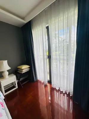 a bedroom with a large window and a wooden floor at Allamanda 2 Laguna Phuket luxuries 1 bedroom in Laguna Phuket