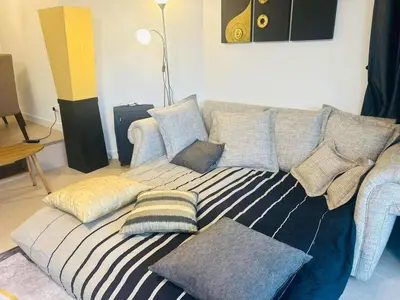 a couch with pillows on it in a living room at Allamanda 2 Laguna Phuket luxuries 1 bedroom in Laguna Phuket