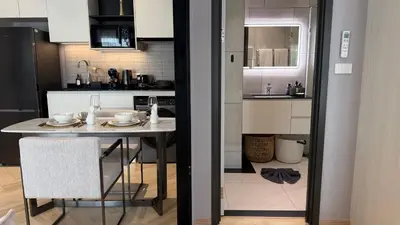a kitchen with a table and a dining room at Cozy Apartment 1 km to Bangtao beach in Bang Tao Beach