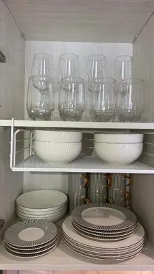 a bunch of wine glasses and plates on a shelf at Cozy Apartment 1 km to Bangtao beach in Bang Tao Beach