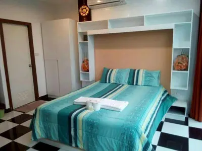 a bedroom with a bed with two towels on it at TK Apartment By Wijitra in Ban Saiyuan (1)
