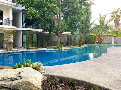 a swimming pool in front of a building at Apartment Title II, Rawai Phuket in Rawai Beach