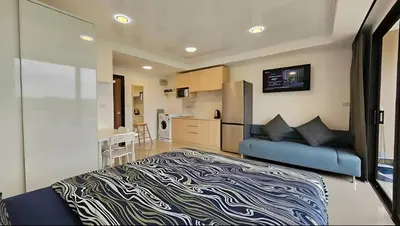 a bedroom with a blue bed and a kitchen at CC620 View of Green Hills in Ban Mai Salae