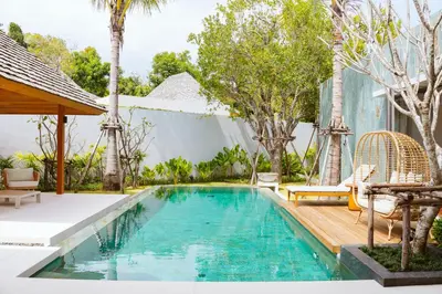 a swimming pool in the backyard of a villa at Anchan Flora Luxury 2BR Pool Villa in Thalang