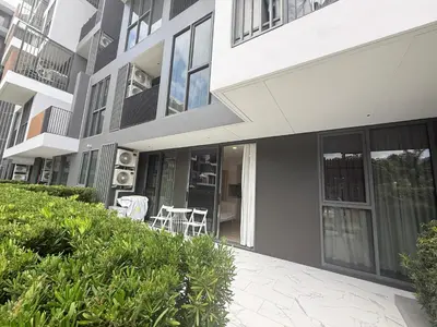 a building with a patio and a table and chairs at Laguna cozy 2 bedroom apartment 5min to the beach in Laguna Phuket