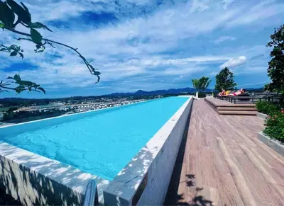 a swimming pool with a view of a city at Laguna cozy 2 bedroom apartment 5min to the beach in Laguna Phuket