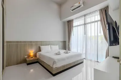 a bedroom with a bed and a large window at V144 Luxury Private Pool Villa in Ban Saiyuan (1)