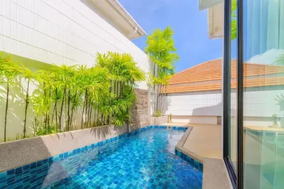 a swimming pool in the middle of a building with trees at V144 Luxury Private Pool Villa in Ban Saiyuan (1)