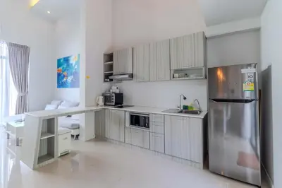 a kitchen with white cabinets and a stainless steel refrigerator at V144 Luxury Private Pool Villa in Ban Saiyuan (1)