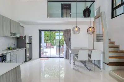 a kitchen with a table and chairs and a dining room at V144 Luxury Private Pool Villa in Ban Saiyuan (1)