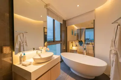 a bathroom with a large tub and a sink at Lakefront suite The Aqua at Boat avenue in Bang Tao Beach