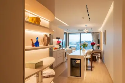 a kitchen and living room with a table and a dining room at Lakefront suite The Aqua at Boat avenue in Bang Tao Beach