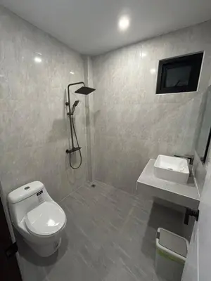 a bathroom with a white toilet and a sink at Luxury 4BR Private Pool Villa Sunset Rooftop in Phuket Town