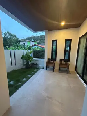 a patio with two chairs in a house at Luxury 4BR Private Pool Villa Sunset Rooftop in Phuket Town