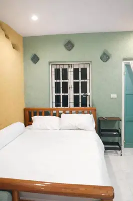 a bedroom with a large white bed and a window at Earth House HomeStay Bangjo in Ban Pak Lak