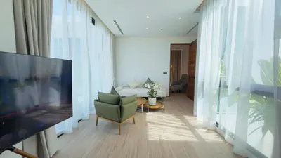 a living room with a television and a couch at Phuvista Villas Naithon by Escape Villas - Brand New 3 BR Pool Villa - 500m from the beach in Phuket Town