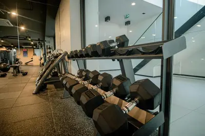 a row of tread machines in a gym at Coastal 1 bd apartment - Moments from the sea in Layan Beach