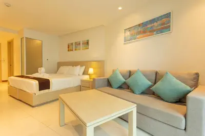 a living room with a bed and a couch and a bed at C109 Beachfront Seaside Escape Pool Access in Ban Saiyuan (1)