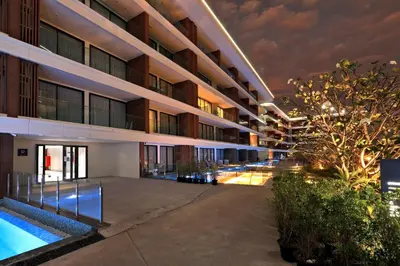 an apartment building with a swimming pool at night at 2BR Layan Beach Apartment Capital Pro Kora D244 in Layan Beach