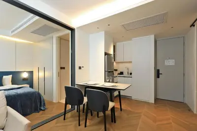 a bedroom with a bed and a table and chairs at 2BR Layan Beach Apartment Capital Pro Kora D244 in Layan Beach