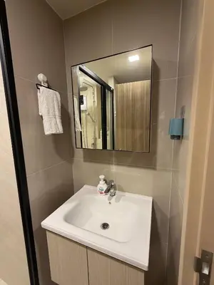 a bathroom with a white sink and a mirror at Phuket, Best location, full furnished 1bedroom in Ban Rangeng