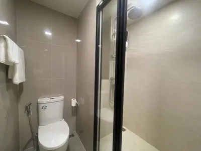 a bathroom with a toilet and a glass shower at Phuket, Best location, full furnished 1bedroom in Ban Rangeng