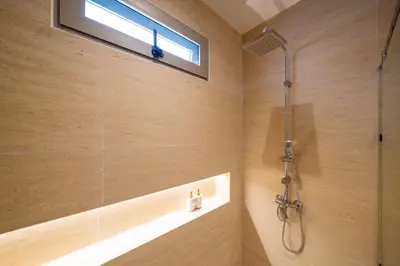 a bathroom with a shower and a window at Duplex 5 & 4 BR Private Pool Villa - Laguna Phuket in Laguna Phuket