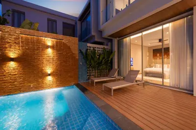 a house with a swimming pool and a bedroom at Duplex 5 & 4 BR Private Pool Villa - Laguna Phuket in Laguna Phuket