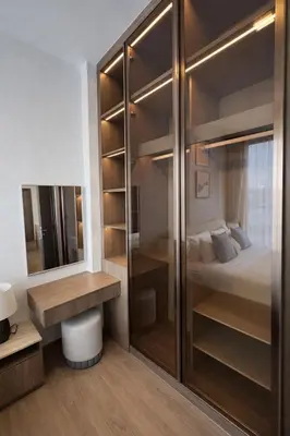 a bedroom with a bed and a desk and a closet at 2BR Apartment, 10-Min Walk to the Beach in Laguna Phuket