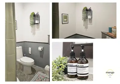 a bathroom with a toilet and three bottles of wine at Mango Moon Phuket Art Haus 1 BR Near Central Phuket in Ban Nong Chaeng