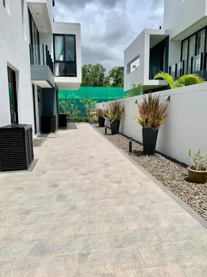 a walkway in front of a building with potted plants at 6-Bedroom Villa in Laguna Park 2 Phuket in Ban Phru Champa