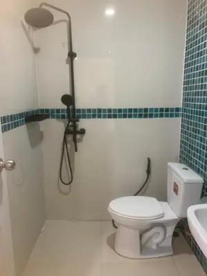 a bathroom with a shower and a toilet and a sink at Nai Yang Guest House in Nai Yang Beach