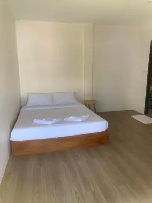 a bed with two towels on it in a room at Nai Yang Guest House in Nai Yang Beach