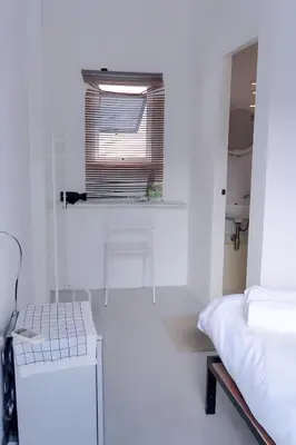 a white room with a bed and a window at XX Bao Patong Beach - เบา ป่าตอง ภูเก็ต in Patong Beach