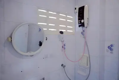 a bathroom with a mirror and a shower at XX Bao Patong Beach - เบา ป่าตอง ภูเก็ต in Patong Beach