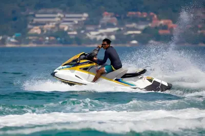 a man riding a jet ski in the water at XX Bao Patong Beach - เบา ป่าตอง ภูเก็ต in Patong Beach