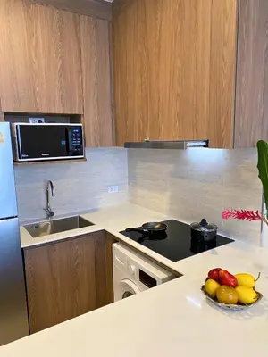 a kitchen with a bowl of fruit on a counter at New 2 Br Apartment Cherng talay in Laguna Phuket
