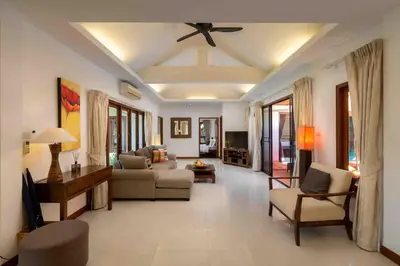 a living room with a couch and a ceiling fan at Sea Breeze Pool Villa on Quiet Kamala Cul de sac in Kamala Beach