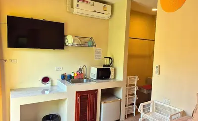 a small kitchen with a sink and a microwave at Jasmine Seaview 'C' Friendly Guest House in Ban Saiyuan (1)