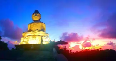 a large statue in front of a sunset at Jasmine's Bungalow 3 bedroom 2 bathrooms Baby Cots in Ban Saiyuan (1)