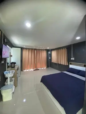 a bedroom with a blue bed and a tv at Villakrabi center in Klong Muang Beach
