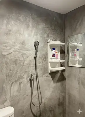 a shower nozzle in a bathroom with a toilet at Villakrabi center in Klong Muang Beach