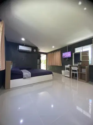 a bedroom with a bed and a desk in a room at Villakrabi center in Klong Muang Beach