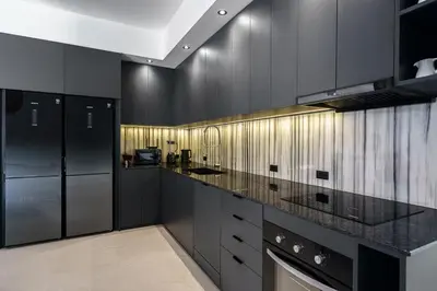 a kitchen with black cabinets and a black counter top at Alex Villa by G Estate Phuket in Ban Saiyuan (1)