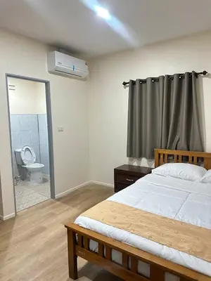 a bedroom with a bed and a bathroom with a toilet at Happy Koh Yao Yai Bangkalo in Ban Tha Rua