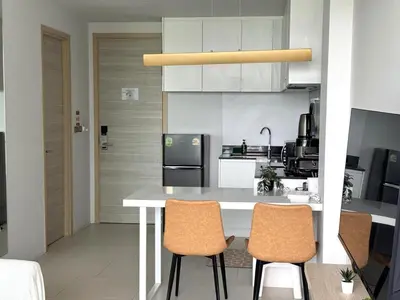 a kitchen with a table and two chairs at A Taste of Utopia -Modern Phuket Retreat with Jacuzzi in Karon Beach