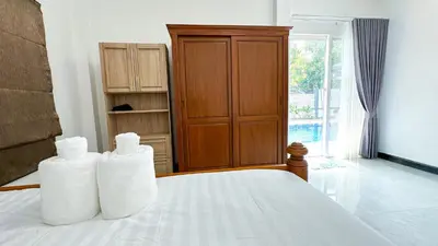 two towels sitting on top of a bed in a room at Soulful Stay Phuket l Phanason Park Ville 1 Near Kathu Waterfall in Ban Kathu