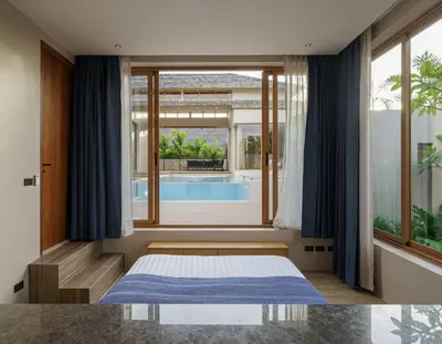 a bedroom with a bed and a swimming pool at Celestia Villas - Pool villa 4BR near Boat Avenue in Ban Pak Lak
