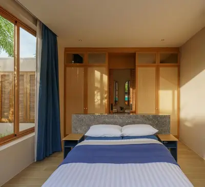 a bedroom with a large bed and a window at Celestia Villas - Pool villa 4BR near Boat Avenue in Ban Pak Lak
